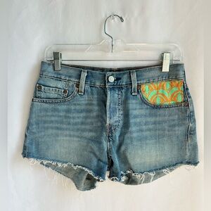 Levi's denim cut-off shorts with unique orange and teal pocket pattern